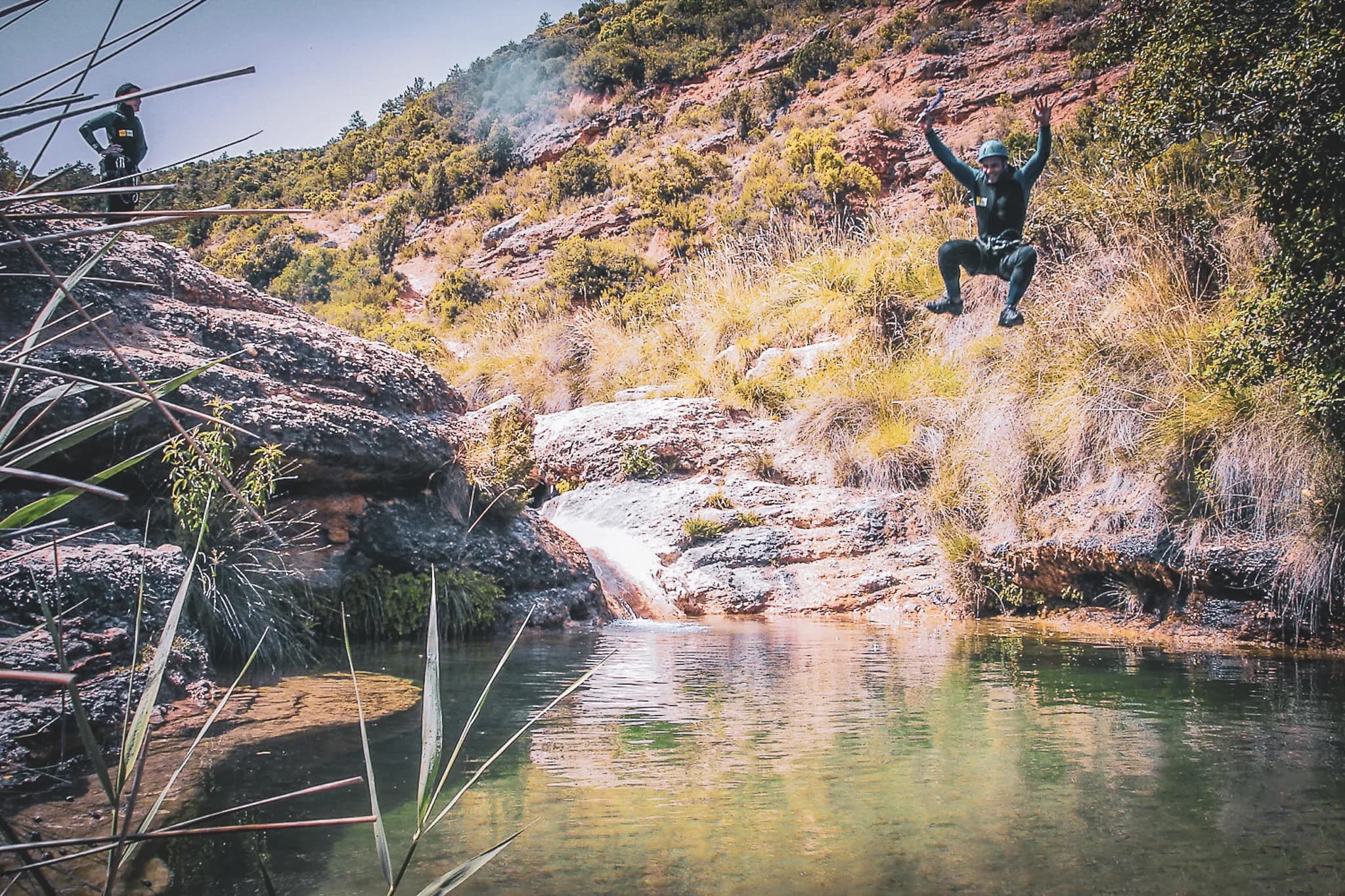 Water adventure in the Sierra de Guara: jump into crystal-clear water surrounded by red rocks.