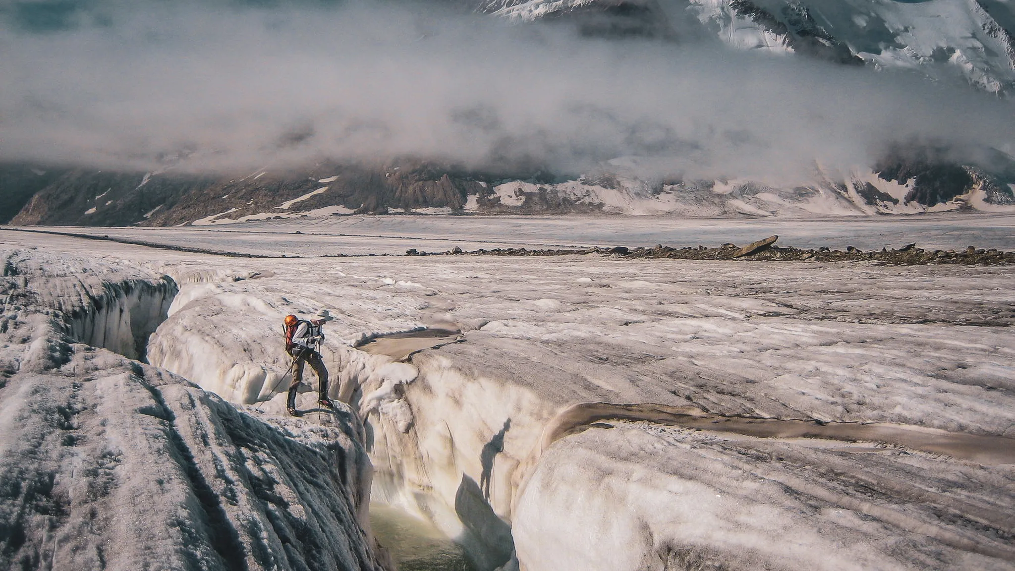 Un randonneur sur le glacier d'Aletsch, face à des paysages époustouflants et des crevasses majestueuses.