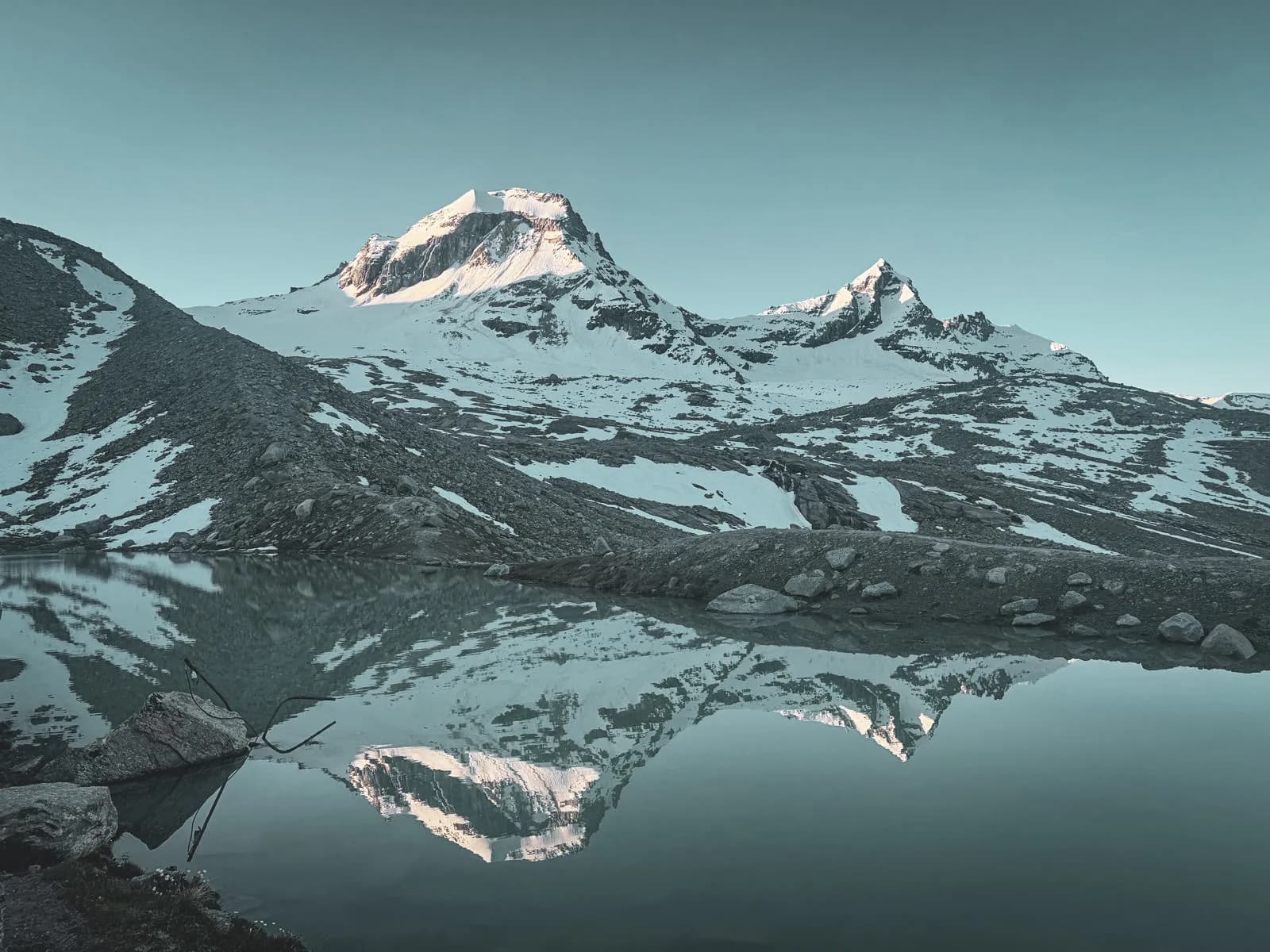 Magnificent Alpine panorama with Gran Paradiso reflected on a peaceful lake.