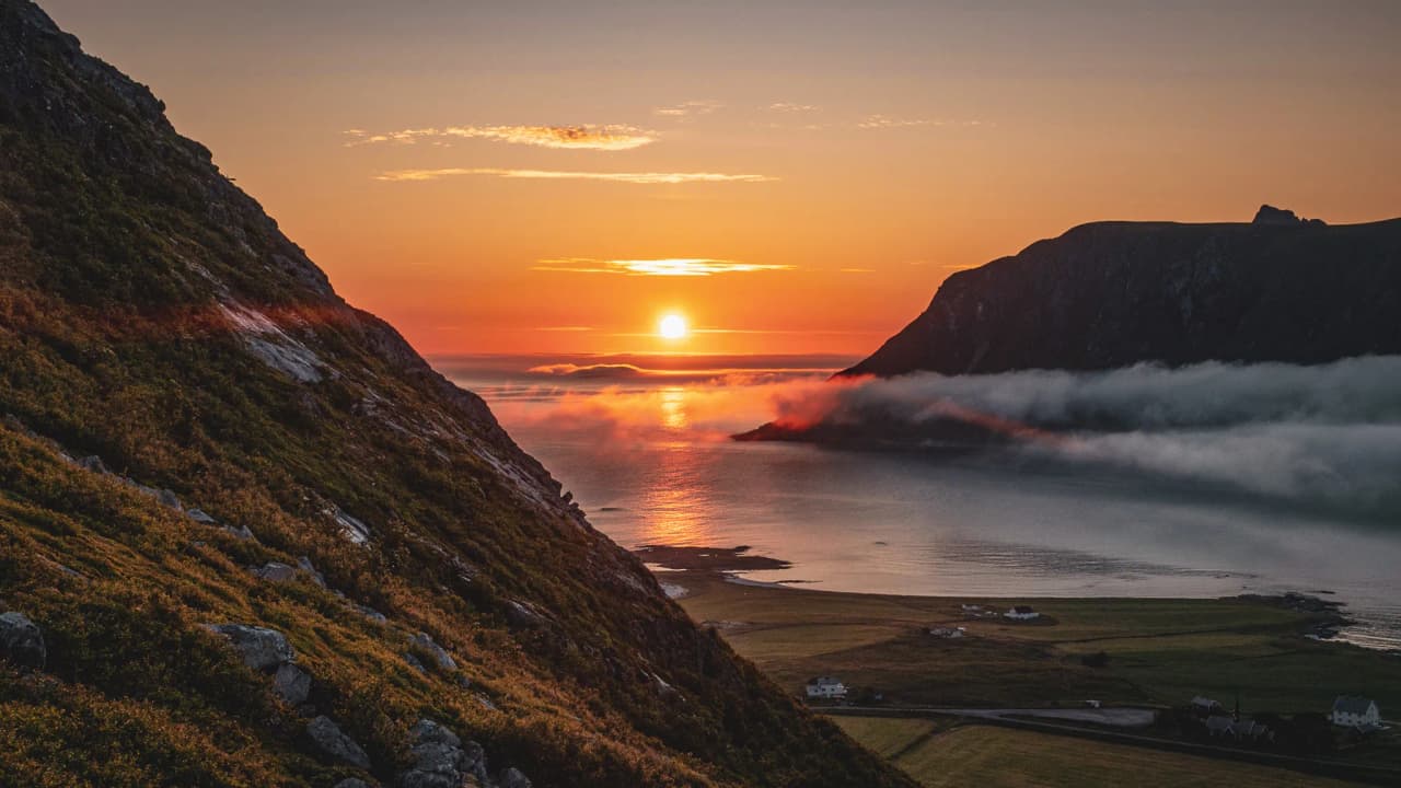 Spectacular sunset over the Lofoten Islands, between mountains and peaceful sea.