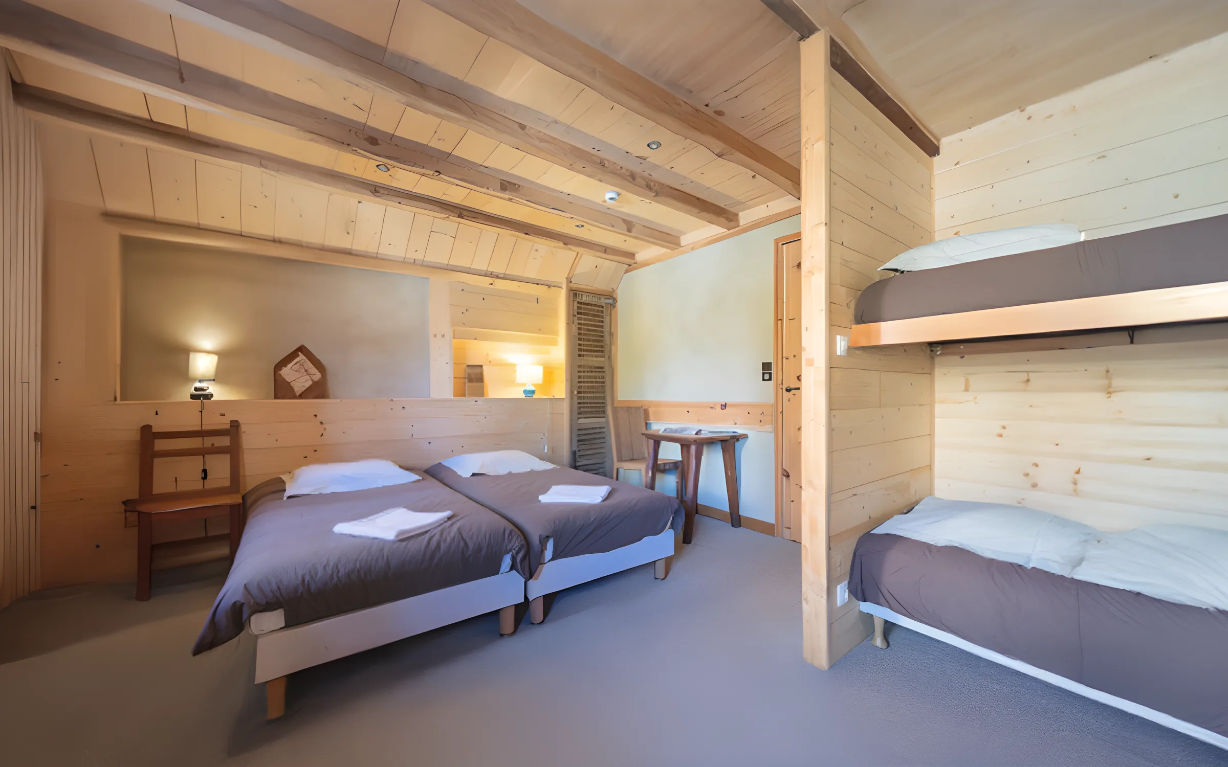 A cosy wooden room with comfortable beds, ideal for recharging your batteries after a day's adventure.