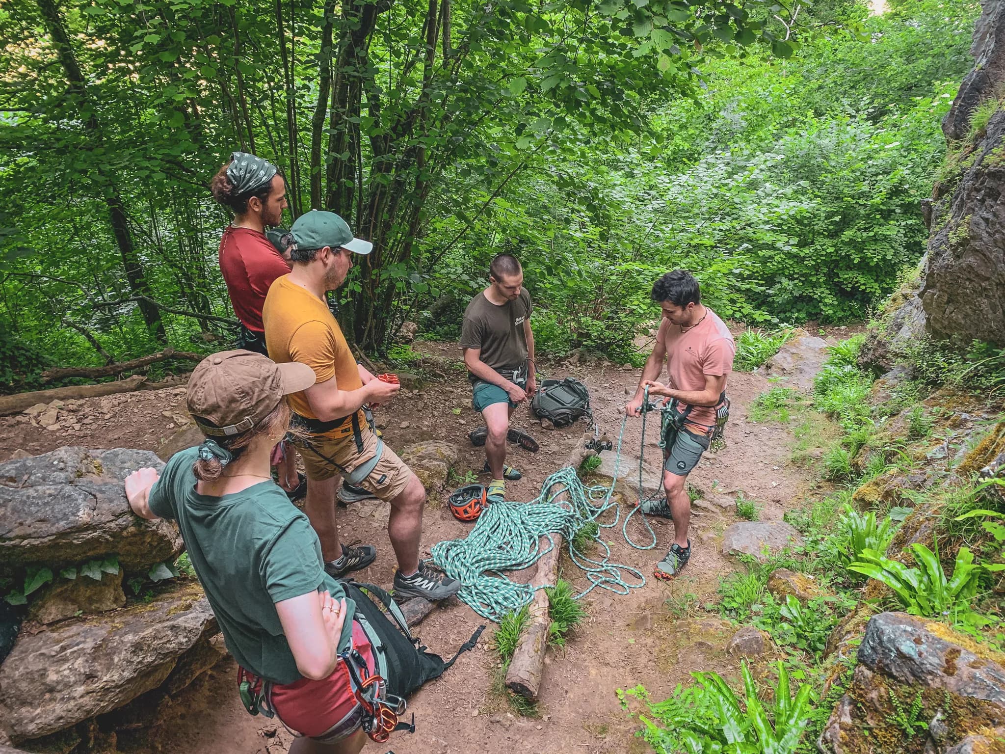 A cliff-climbing group preparing for their adventure in the green countryside of Belgium.