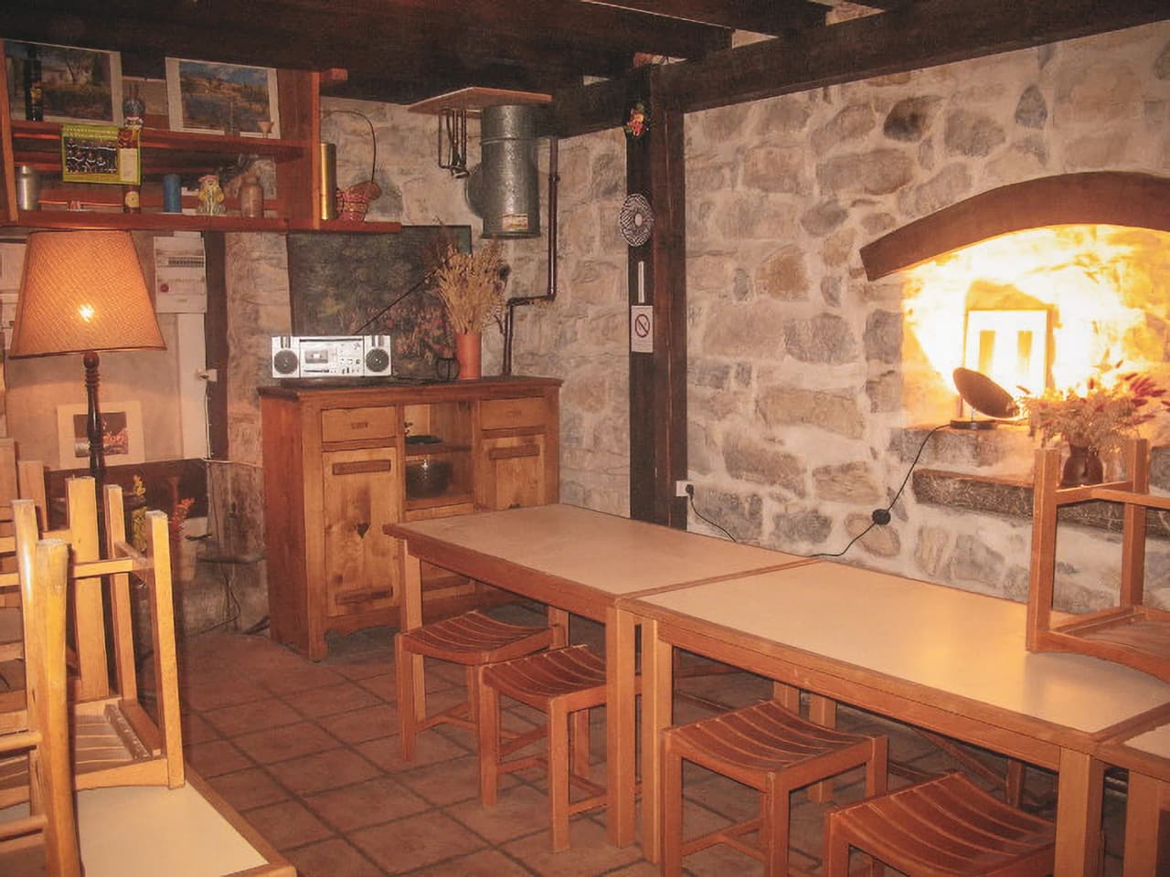 Auberge chaleureuse avec murs en pierres, tables en bois et ambiance conviviale propice à la détente.