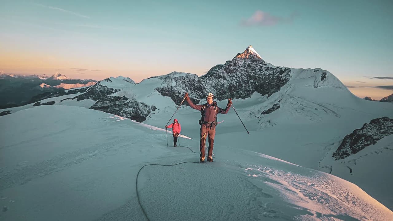 Mountaineers on a glacier on Monte Rosa, marvelling at the sunrise. Breathtaking scenery!