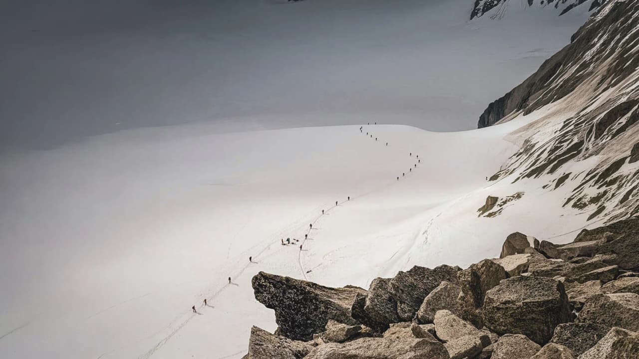 A group of mountaineers on a glacier beneath the majestic peaks of Mont Blanc. An unforgettable adventure!